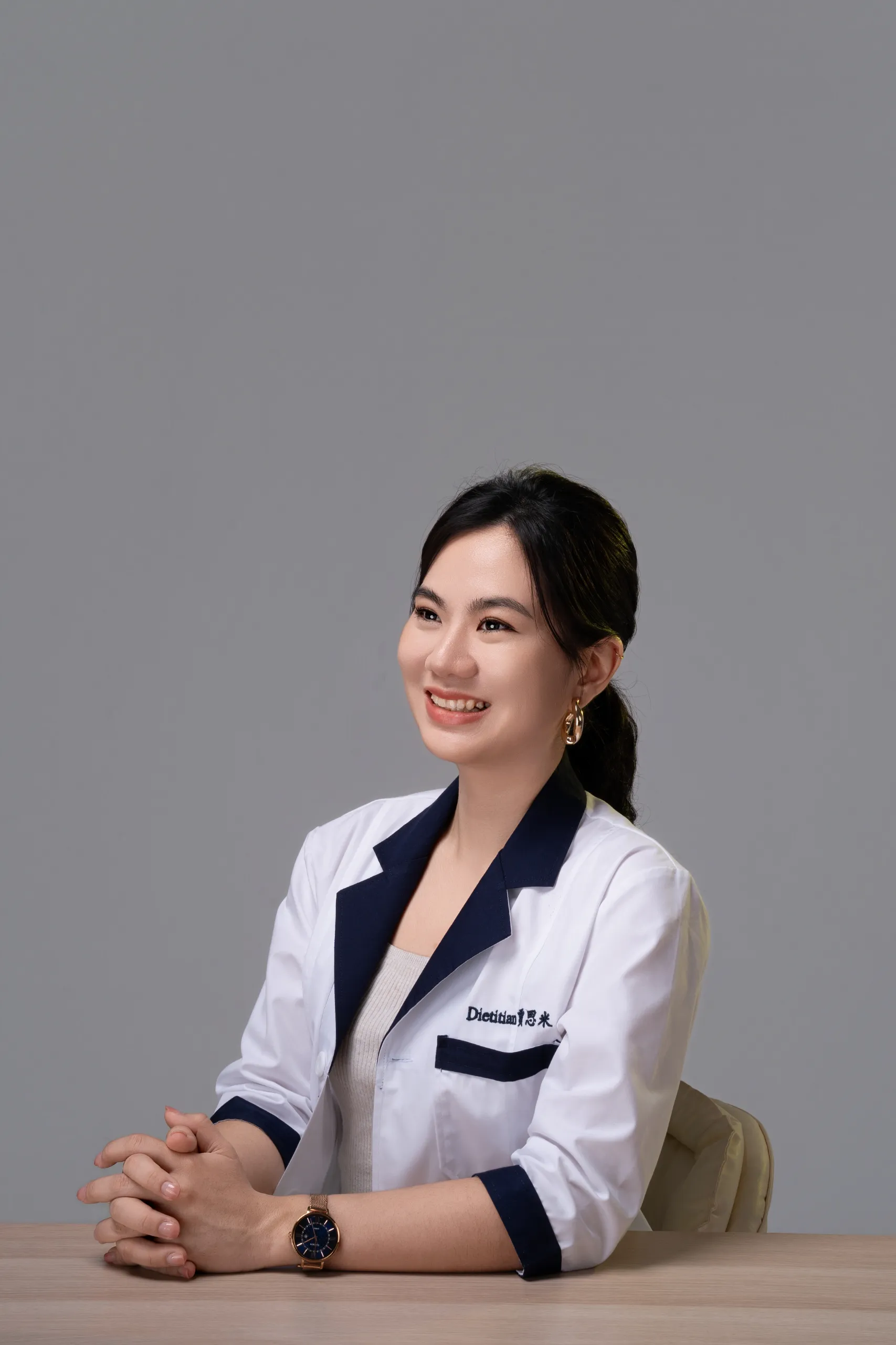 Jaceme Chuah seated at her consultation desk, smiling