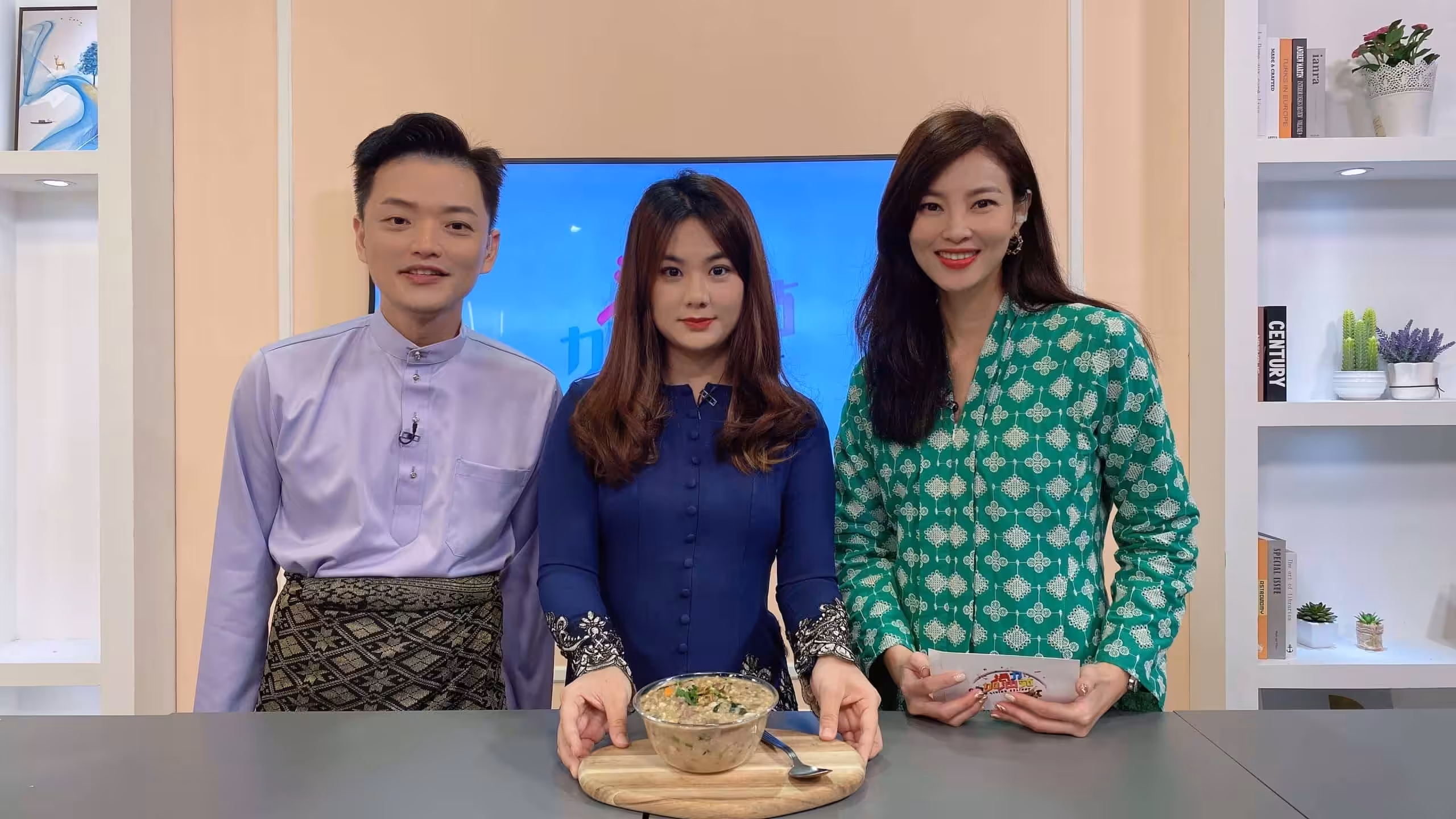 Jaceme Chuah presenting a healthy dish with two hosts during a television segment